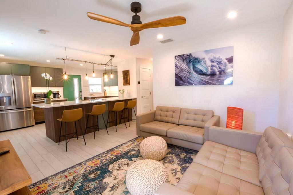 a living room with a couch and a kitchen at TOP RATED! Buddha's Bungalow, near Flagler & Beach in New Smyrna Beach