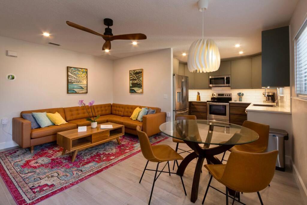 a living room with a couch and a table at NEW Stylish & Cozy Dune Daisy near Beach & Flagler in New Smyrna Beach