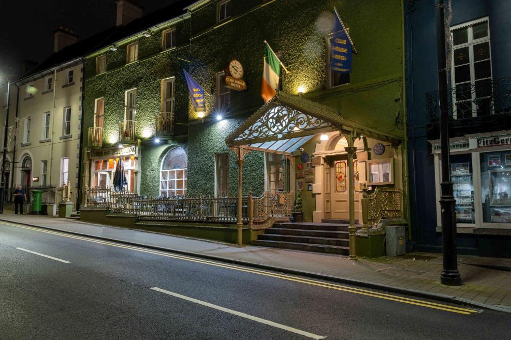 a building on the side of a street at night at Club House Hotel Kilkenny in Kilkenny