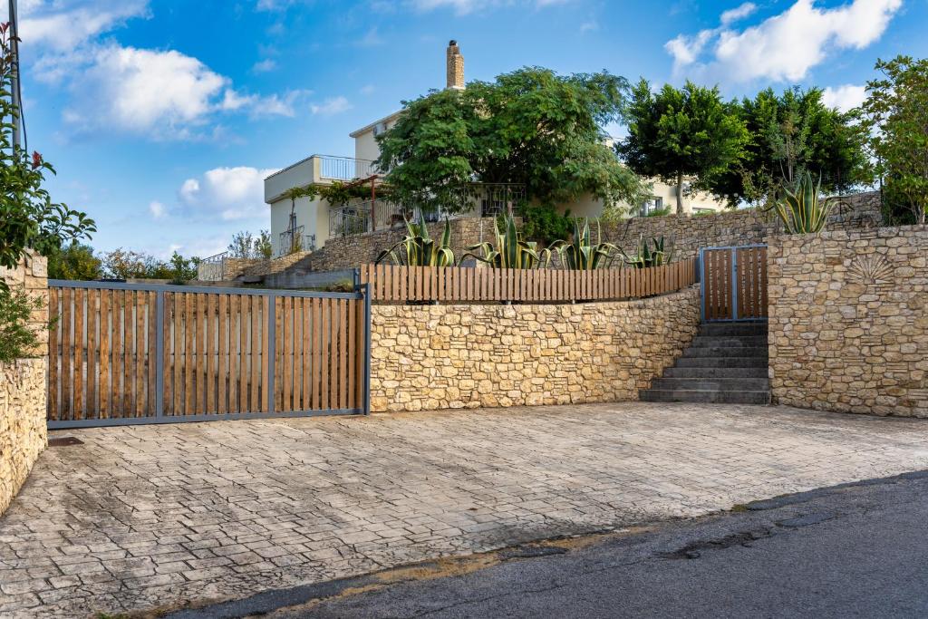 a wooden fence in front of a house at Piperitsa house for nomads or families in the countryside in Messini