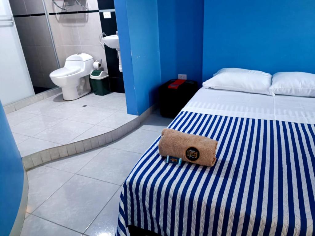 a blue room with a bed with a purse on it at CASA COMPARTIDA in Chiclayo