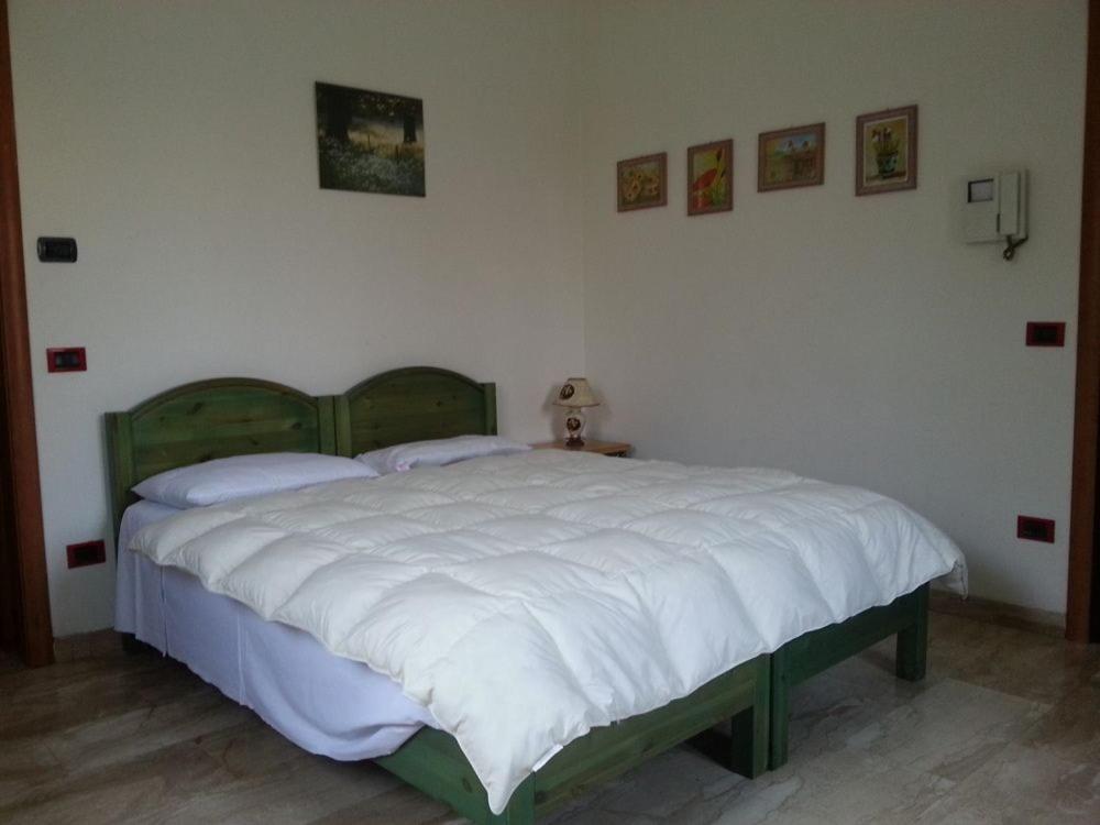 a bedroom with a large bed with white sheets at RESIDENCE LA VECCHIA REGGIO in Reggio Emilia