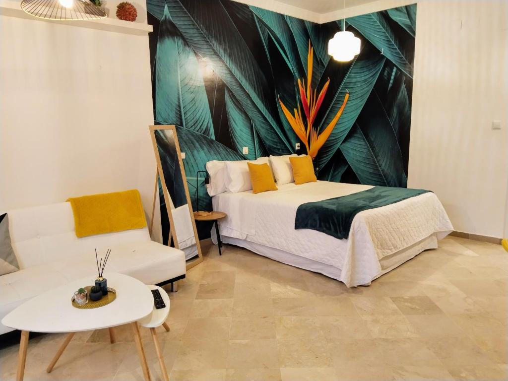a bedroom with a bed and a couch and a table at Apartamentos Serrallo in Granada
