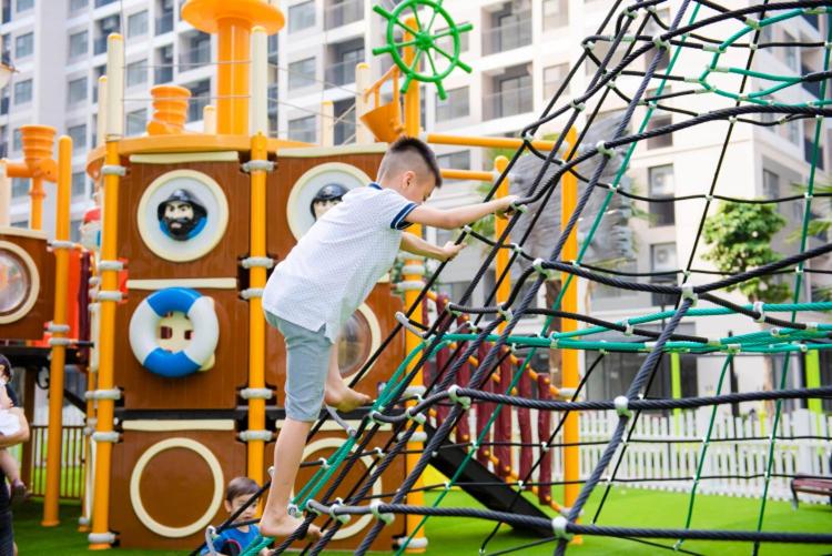 a young boy playing on a playground at Meii House - Vinhome Ocean Park S201 in Hanoi