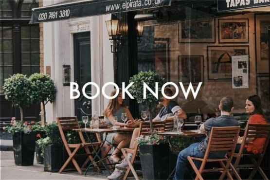 people sitting at a table outside a book now restaurant at Mayfair Town House in London