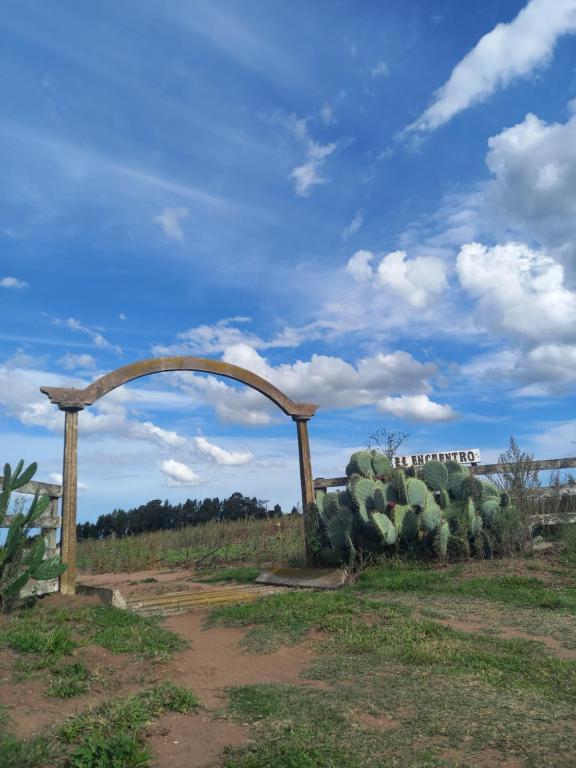 an arch in front of a field of cactus at Casa El Encuentro in San Carlos de Bolívar