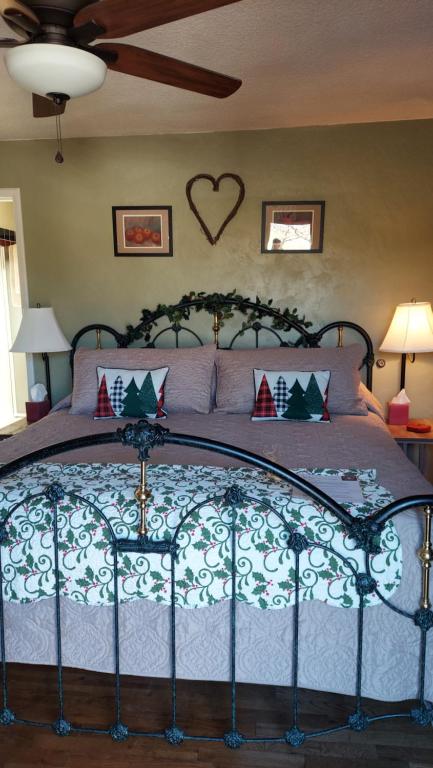 a bedroom with a bed with a heart on the wall at Applinger Farm in Ashland