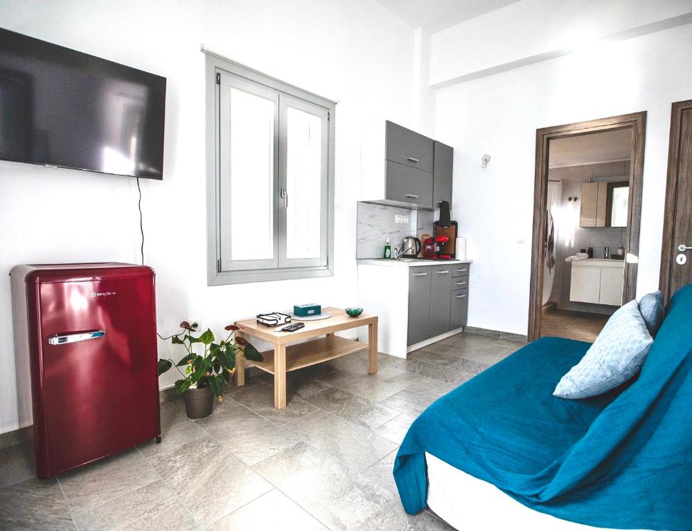 a small kitchen with a red refrigerator in a room at Seaside Serenade 1, suite in Ermoupoli