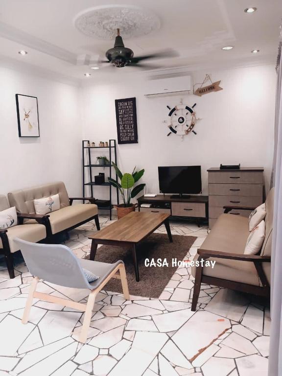 a living room with a couch and a table at CASA Homestay in Batu Pahat