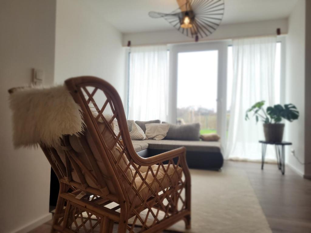 a living room with a rocking chair and a couch at Ferienwohnung Himmelsblick am See in Gries