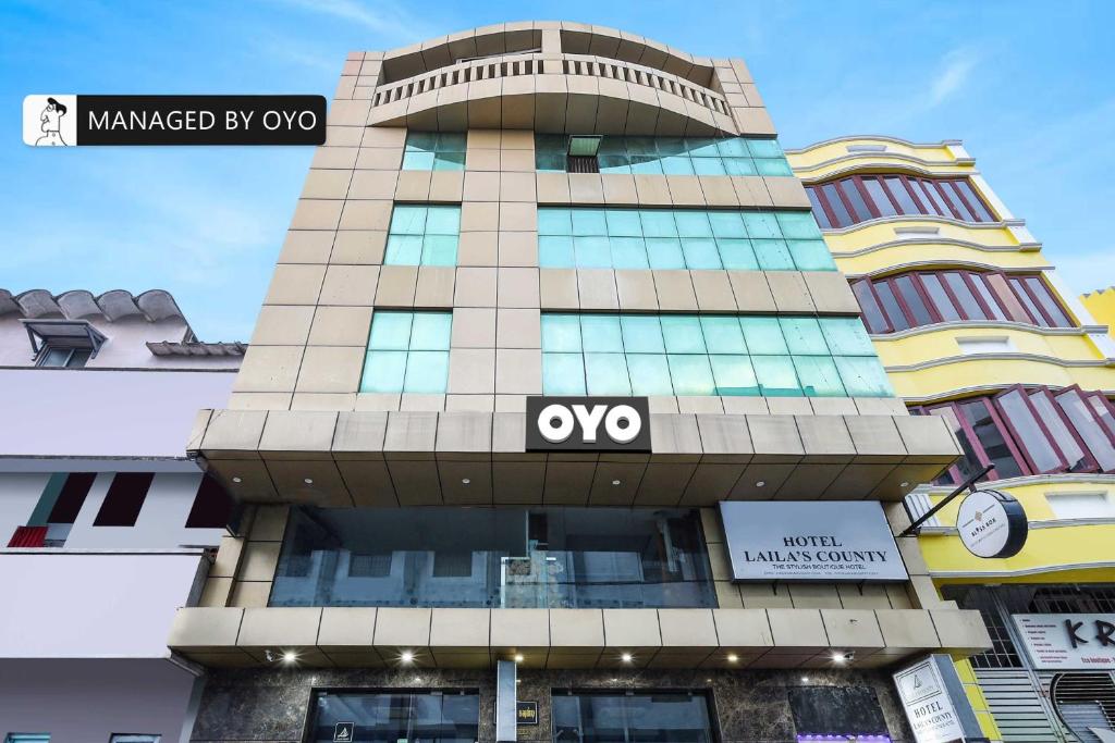 a tall building with an ovo sign on it at Collection O Lailas County Heritage Town in Puducherry
