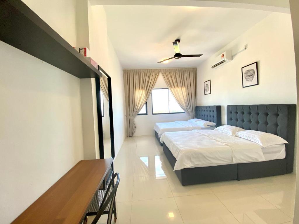 a bedroom with two beds and a table at Terengganu Dreamscapes at Icon Residence, Spacious with Nature View in Kuala Terengganu