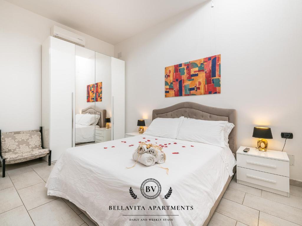 a bedroom with a bed with a stuffed animal on it at BellaVita Apartments in Assemini