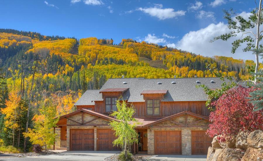 a house with two garage doors in front of a mountain at Black Bear 110 in Durango Mountain Resort