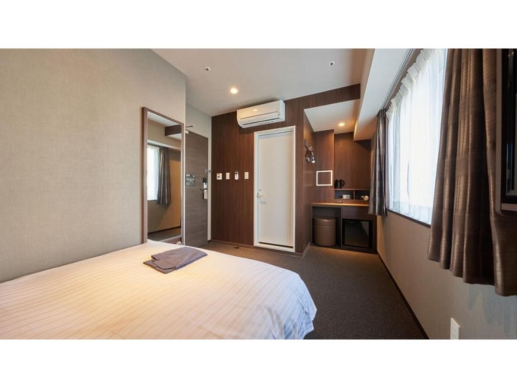 a hotel room with a bed and a kitchen at Welina Hotel Premier Nakanoshima West - Vacation STAY 22043v in Osaka