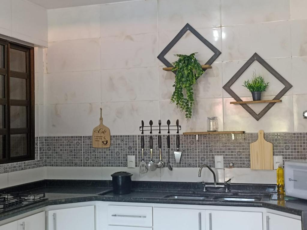 a kitchen with a sink and a counter top at Residencial Vista Bela in Bombinhas