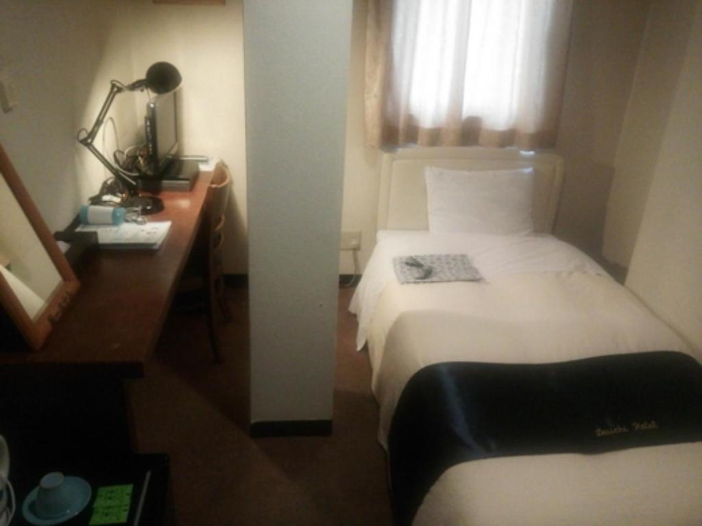 a hotel room with a bed and a desk and a window at Daiichi Hotel - Vacation STAY 24289v in Omihachiman