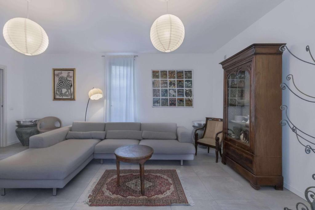 a living room with a couch and a table at Alba House Malpensa Airport in Gallarate