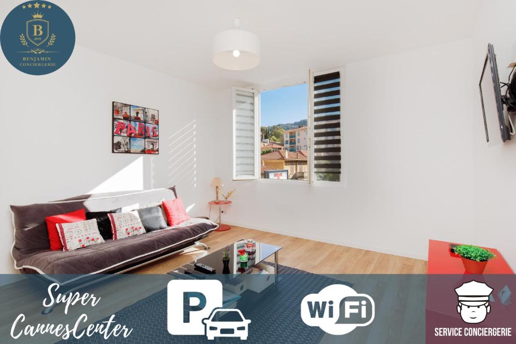a living room with a couch and a window at SuperCannes Center - Parking - Spacieux 70 Metres - Clim - Wifi in Cannes