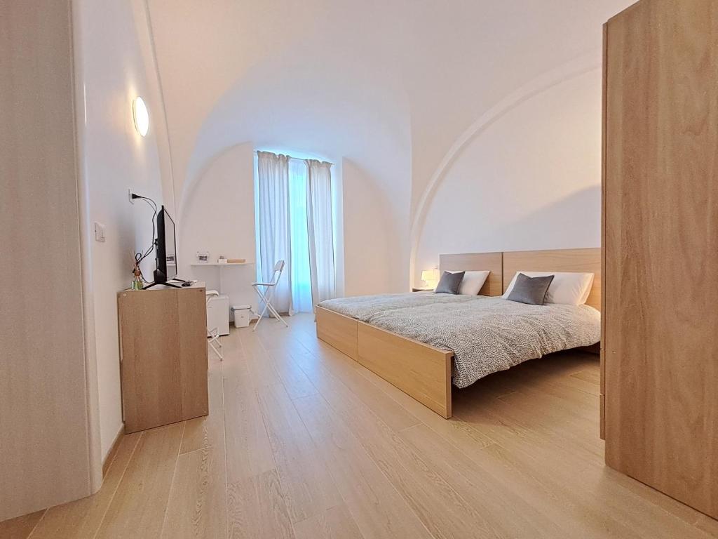Postel nebo postele na pokoji v ubytování la casa sull arco