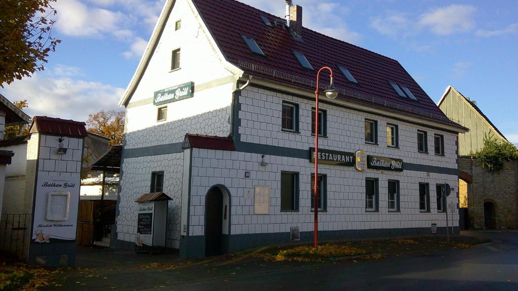 a large white building with a red roof at Unseburg-Ferienwohnung 5 