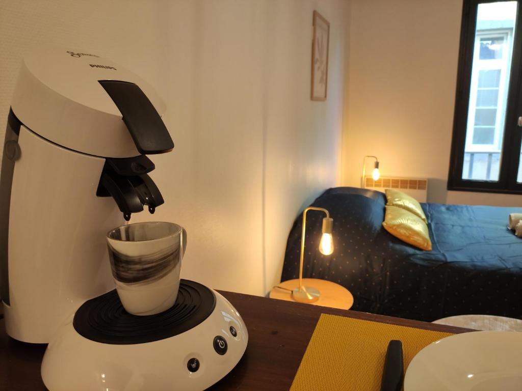 a coffee maker sitting on a table in a room at Le Charme - Focalimmo (Centre) in Foix