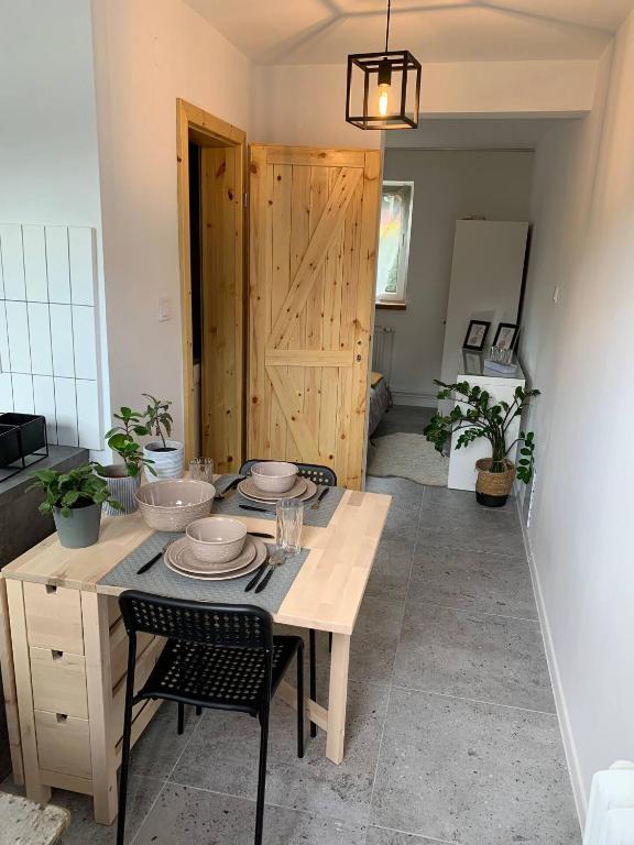 a dining room with a table with dishes on it at LOFT-LUX Apartment in Jelenia Góra