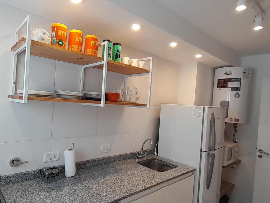 a kitchen with a sink and a refrigerator at Depto Centro 2 amb para 2 o 3 personas Cochera in Mar del Plata