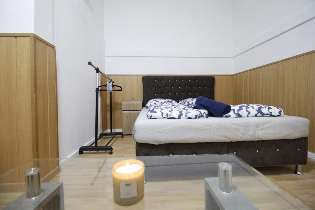 a bedroom with a bed with a candle on the floor at Premier Double room TH a in Vienna