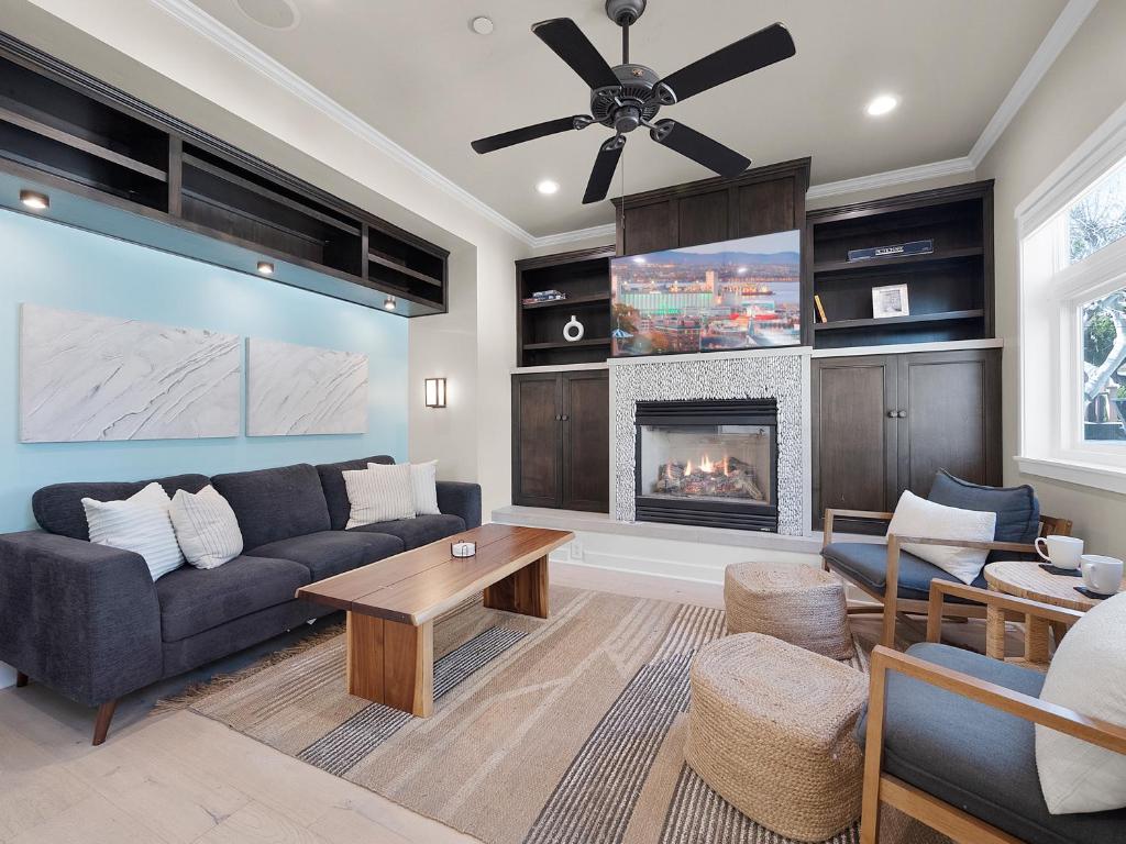 a living room with a couch and a fireplace at Kennebeck Oasis - Private Patio, Steps 2 Sand & AC in San Diego