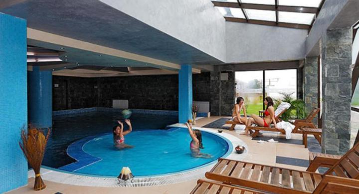 a group of people in a swimming pool at VIP Apartments Belvedere with terrace K105 in Bansko