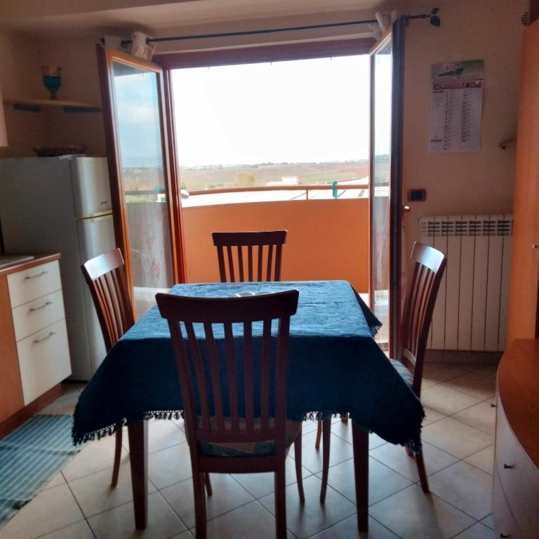 a kitchen with a table and chairs and a window at Daniele's home close to Rome in Pomezia