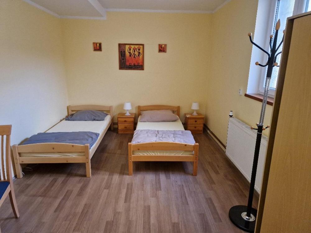 a room with two beds in a room at Penzion Kornout in Bílina