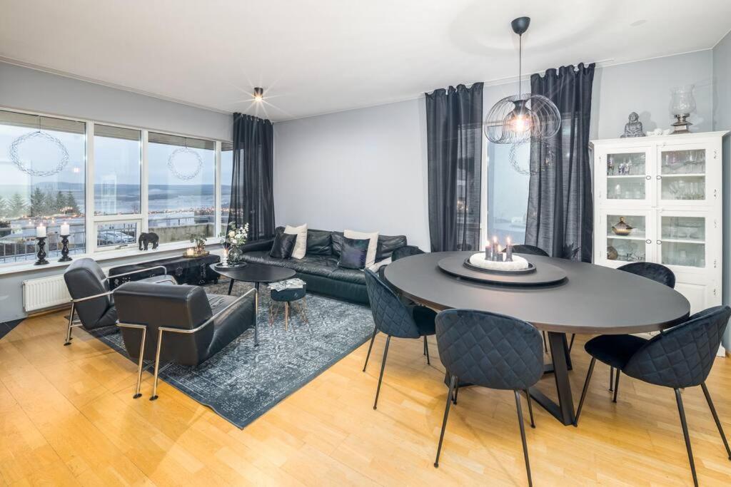 a living room with a table and chairs at Kopavogur Cozy Nest (3-bedrooms) in Reykjavík