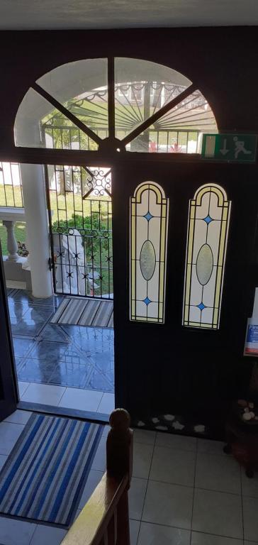 an entry to a house with stained glass windows at Happy Grove Lodge in Happy Grove