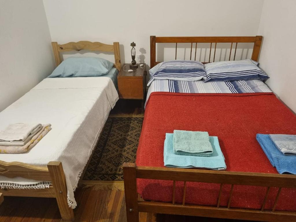 ブエノスアイレスにあるHotel Cubaの部屋にはタオルが敷かれたベッドが2つある