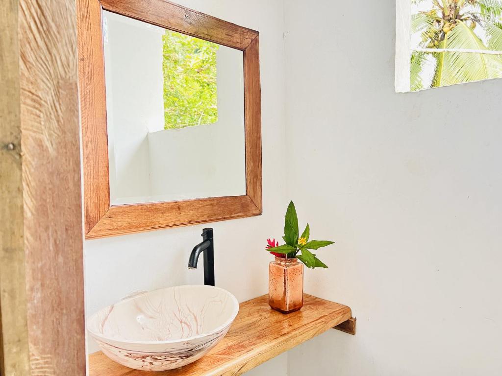 a bathroom with a sink and a mirror at Utria hostel in El Valle