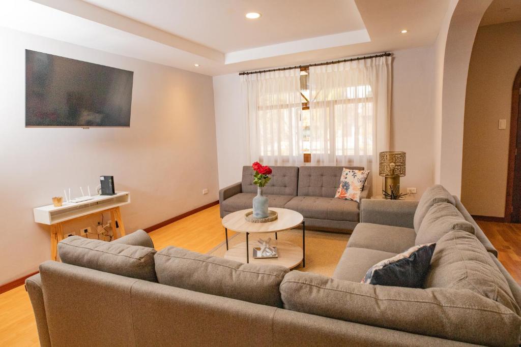a living room with a couch and a table at Santa Lucia Suites - Barranco in Cuenca