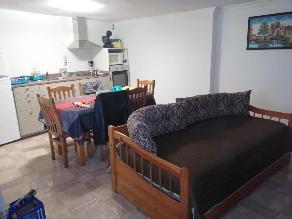 1 dormitorio con cama, mesa y cocina en Casa Véronique, en Soajo