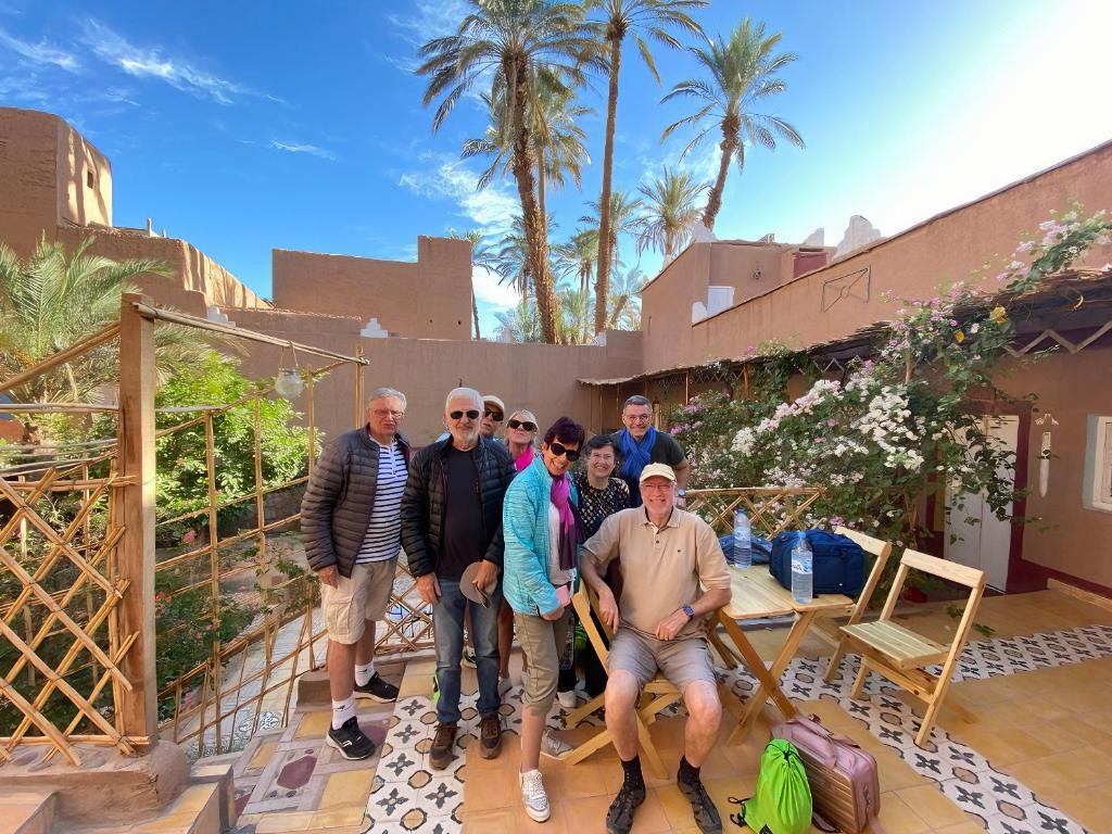 a group of people posing for a picture in front of a house at Riad Dar Zaouia in Zagora
