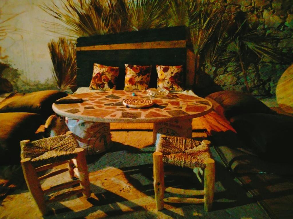 a painting of a living room with a table and chairs at Ocean Jam Surf House in Agadir