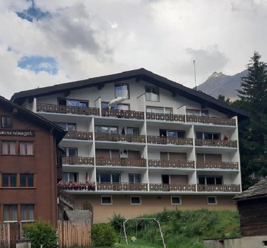 a large building with balconies on the side of it at Appartement Mittaghorn Saas-Fee in Saas-Fee