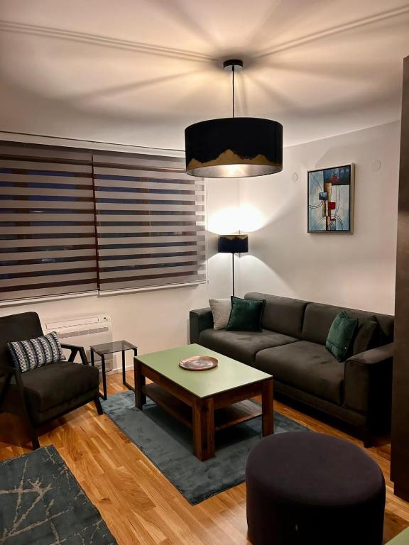 a living room with a couch and a table at Pale Green in Pale