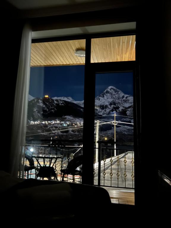 a view of a mountain from a window at Highland Kazbegi in Stepantsminda