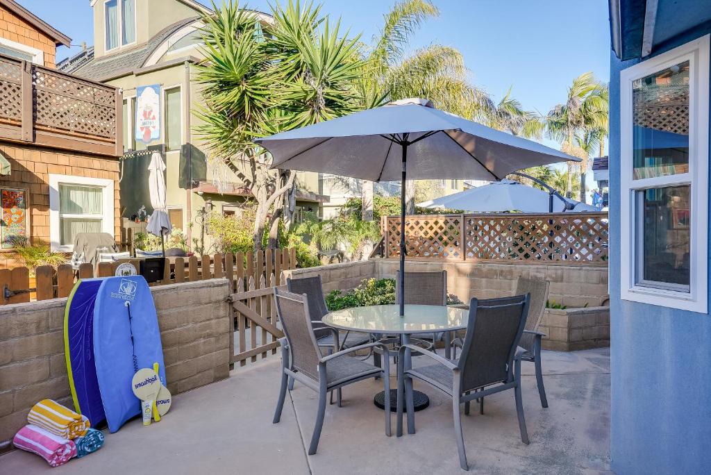 a table and chairs with an umbrella on a patio at Beautiful Beach Home - Ocean View, AC & Patio in San Diego