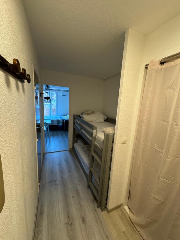 a small room with a bed and a hallway at Studio avec terrasse vue sur cousson in Digne-les-Bains