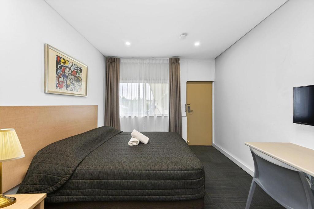 Postel nebo postele na pokoji v ubytování Westside Motor Inn