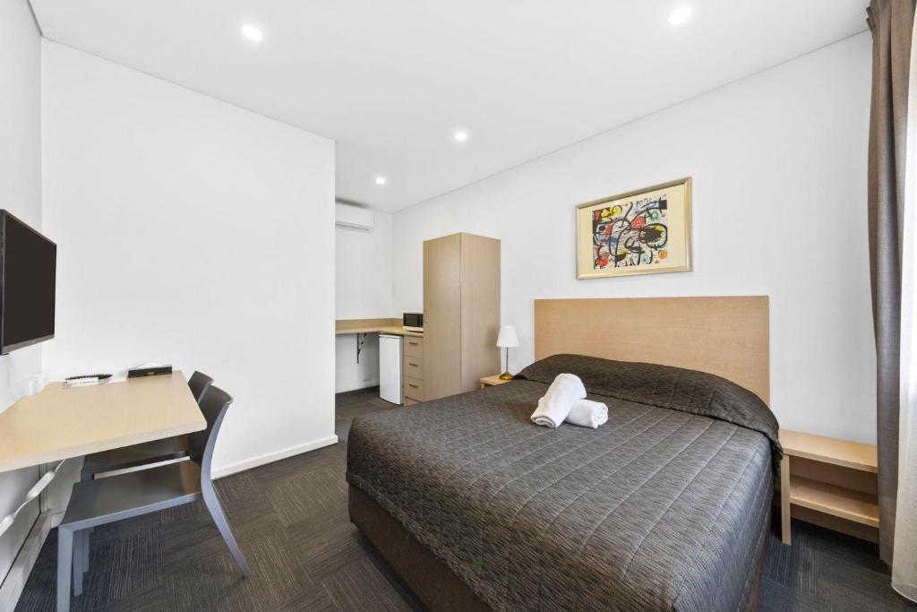 Postel nebo postele na pokoji v ubytování Westside Motor Inn