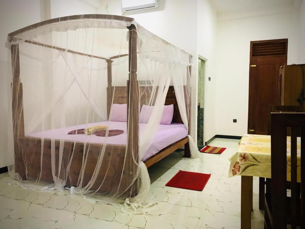 Postel nebo postele na pokoji v ubytování Green jade Inn Mirissa