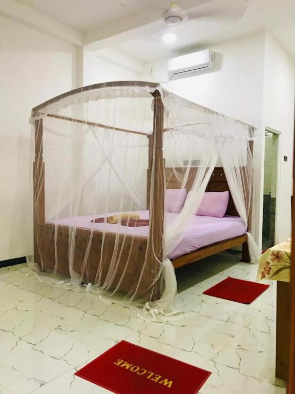 Postel nebo postele na pokoji v ubytování Green jade Inn Mirissa